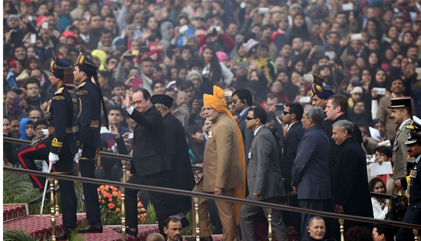 French President Francois Hollande waves as he arrives alongside Indian Prime Minister Modi