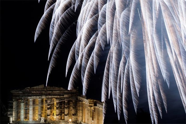 Fireworks erupt over the ancient Parthenon temple atop Acropolis hill in Athens, Greece