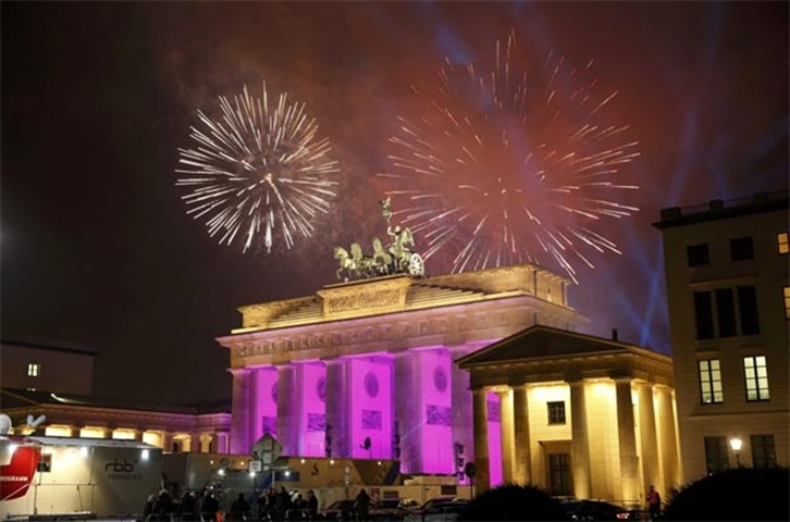 Fireworks erupt next to the Quadriga sculpture atop the Brandenburg gate in Berlin