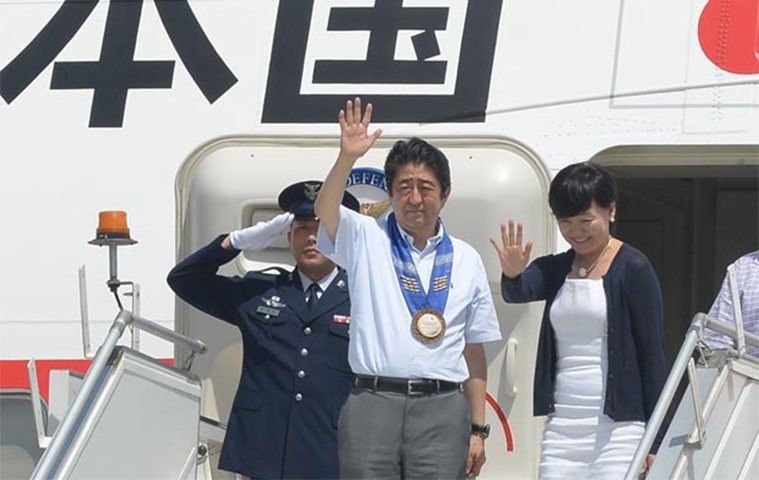 Shinzo Abe and wife wave to well-wishers at Davao international airport at the end of their visit
