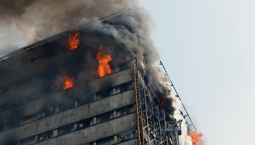 Firefighters battle a blaze that engulfed Iran\'s oldest high-rise, the 15-storey Plasco building