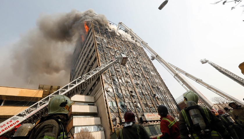 Firefighters battle a blaze that engulfed Iran\'s oldest high-rise, the 15-storey Plasco building