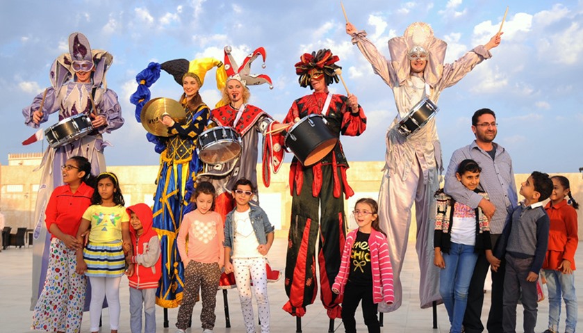 Stilt walkers dressed in colourful costume entertain young visitors. PICTURE: Ram Chand