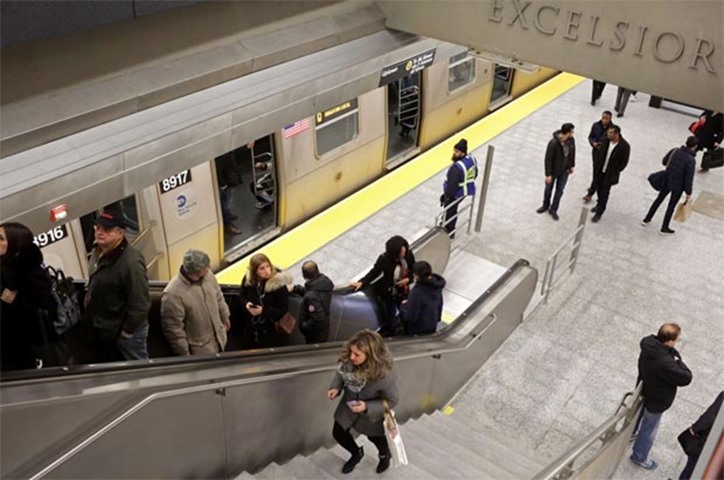 Commuters exit the uptown Q train at the 86th St. station on the newly opened line