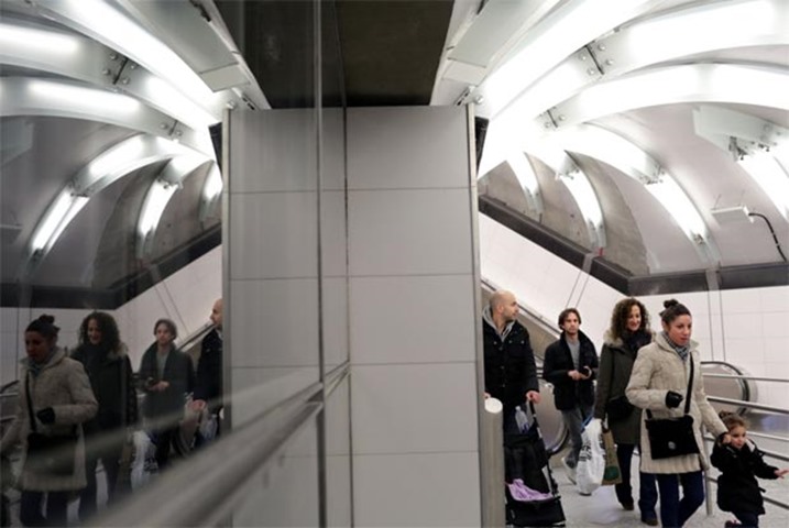 Commuters enter the 86th St. Q train station in New York City on Sunday