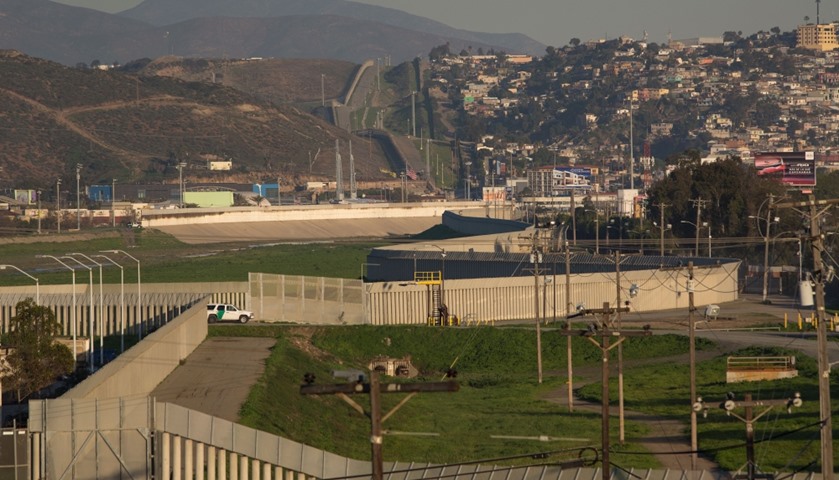 The border wall as seen as viewed from the United States side (L) near Tijuana, Mexico