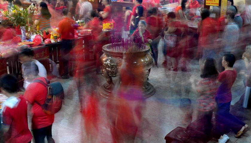 Members of the Chinese community offer prayers inside the Seng Guan temple