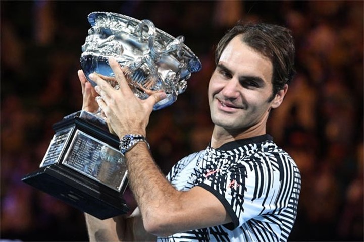 Roger Federer holds the championship trophy after winning the Australian Open