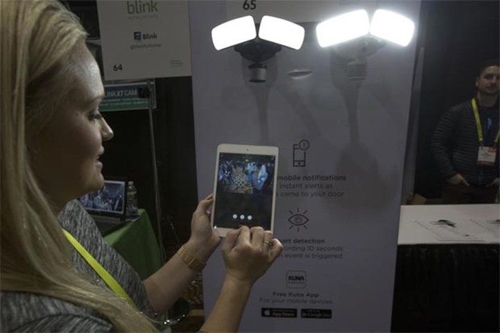 An exhibitor uses an app to operate the Maximus Smart Motion Security Light