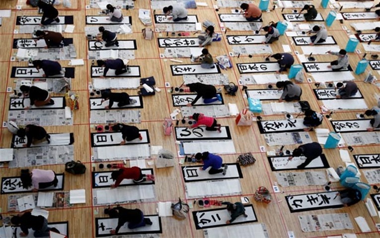 Japanese take part in a New Year calligraphy contest in Tokyo on Thursday