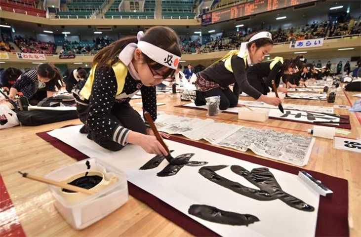 A young contestant writes calligraphy during the annual New Year contest in Tokyo