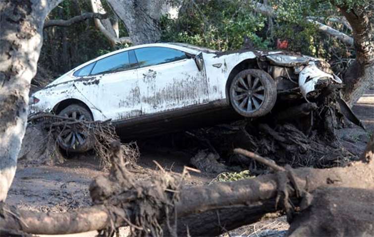 A car sits tangled in debris after being destroyed by mudslides in Montecito, California