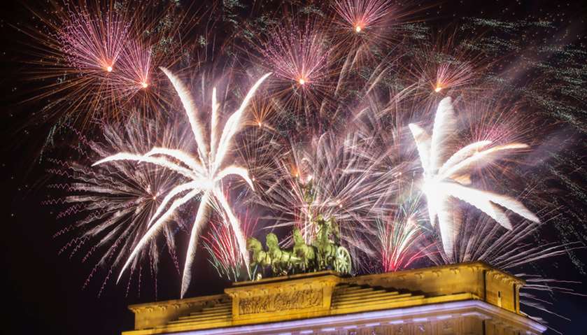 Fireworks explode over the Quadriga sculpture atop the Brandenburg gate during New Year celebrations