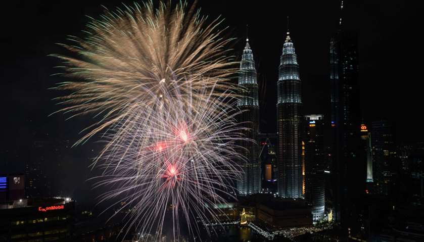 Fireworks illuminate the sky near Malaysia\'s Petronas Twin Towers during New Year celebrations