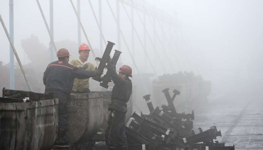 Chinese employees work during heavy fog in Huaibei, eastern Anhui, China