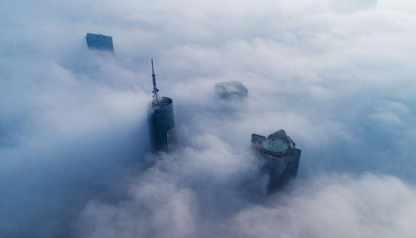 Skyscrapers are seen shrouded in fog in Hefei, Anhui province, China