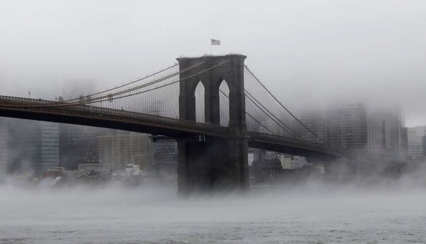 The Brooklyn Bridge is seen partially in fog New York, US