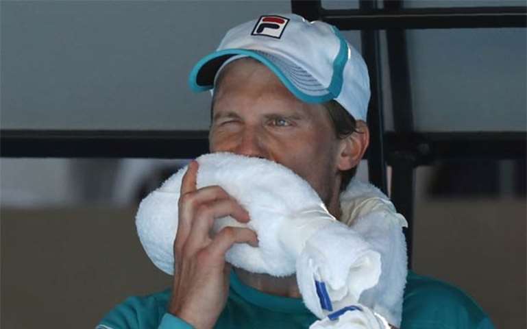 Andreas Seppi of Italy rests during his match against Ivo Karlovic of Croatia