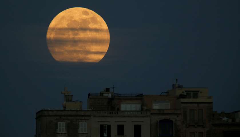 A \'supermoon\' full moon is seen rising in Pieta, Malta