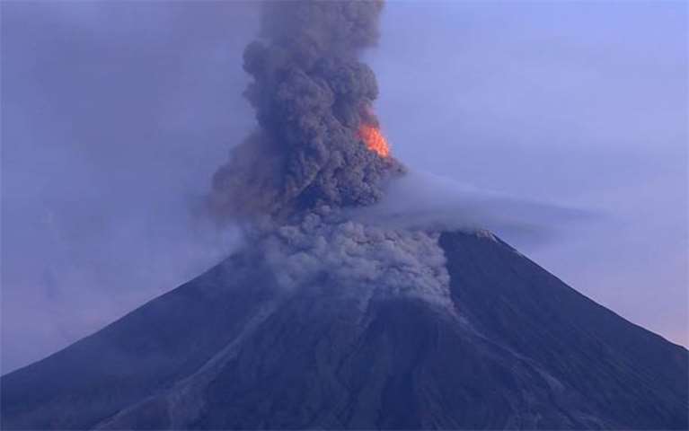 A photo taken from a drone shows ash shooting up from the Mayon volcano