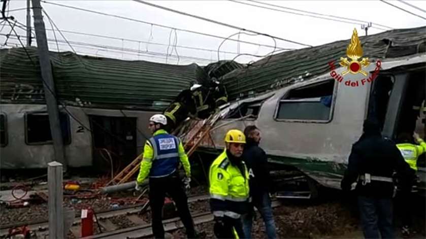 Firemen working on the site of a train derailment near Milan on Thursday