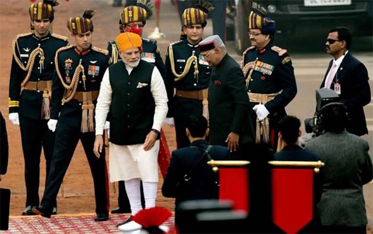 Prime Minister Narendra Modi looks on as President Ram Nath Kovind arrives to attend the parade
