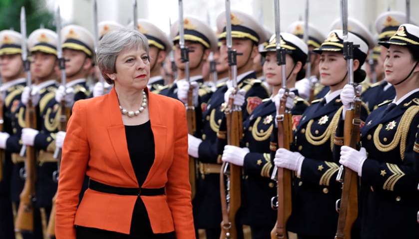 British Prime Minister Theresa May reviews honour guards during a welcoming ceremony