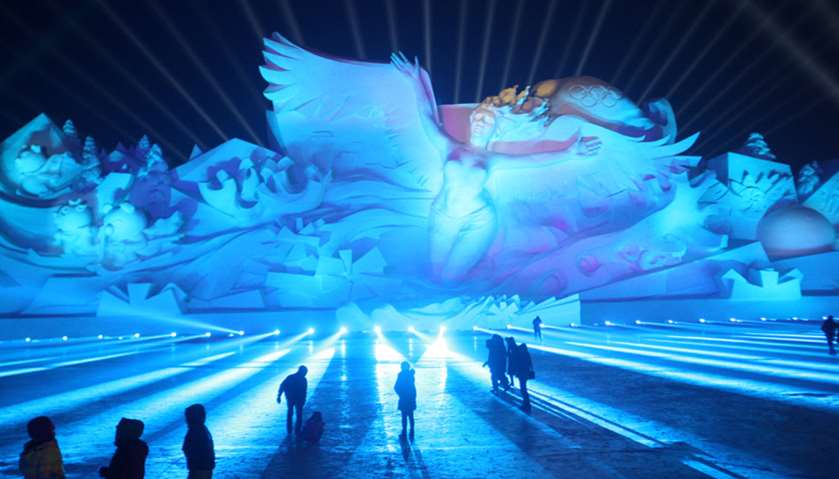 Visitors attend a 3D light show at the Harbin International Snow Sculpture Art Festival