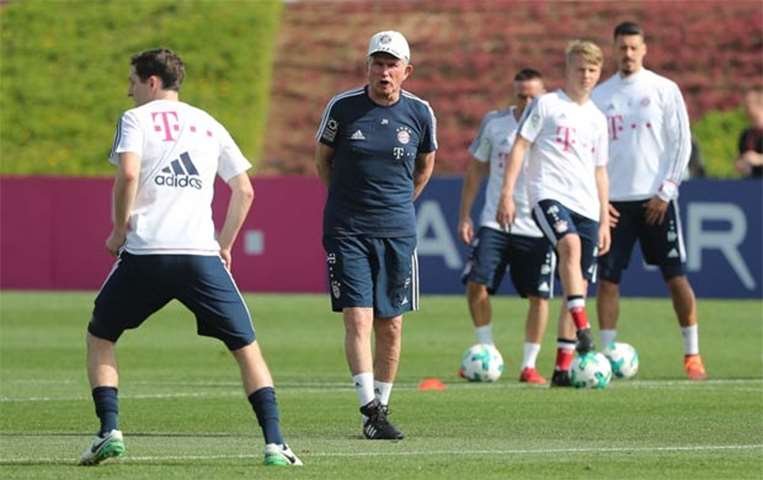 Bayern Munich\'s coach Jupp Heynckes (centre) overlooks a training session in Doha
