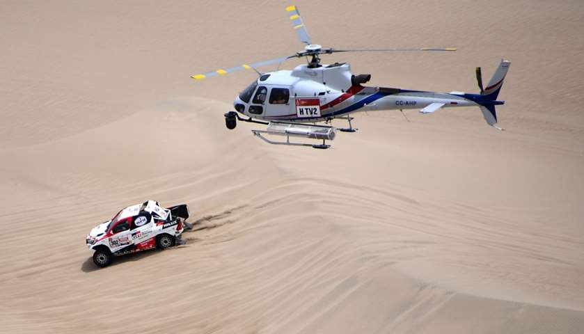 Toyota\'s driver Nasser Al-Attiyah of Qatar and his co-driver Mathieu Baumel of France compete