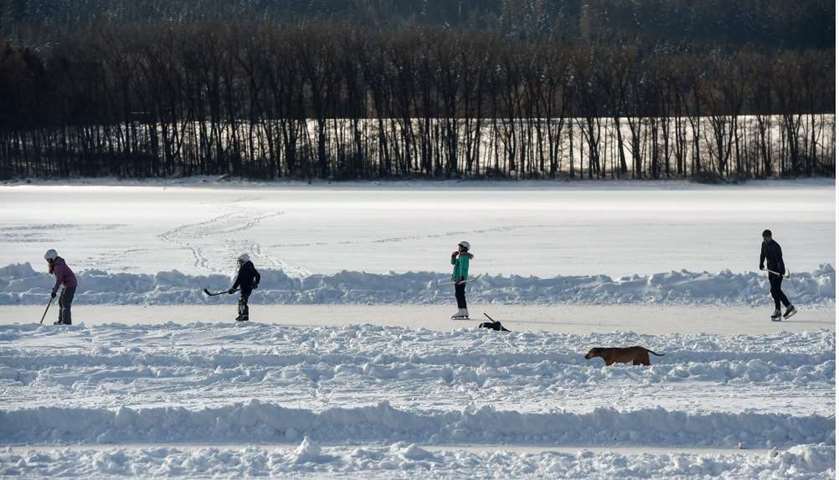 People play ice-hockey at the frozen Lipno dam on Vltava river, Czech Republic