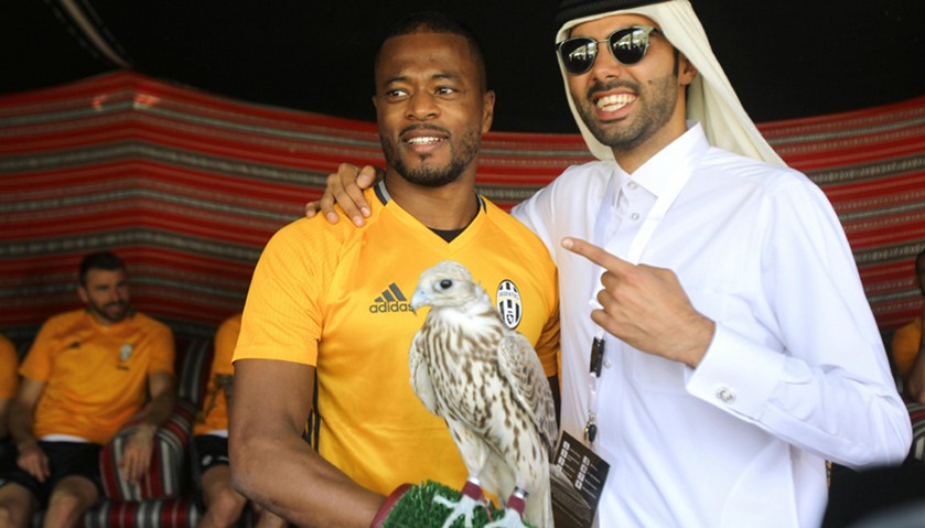 Juventus\' Patrice Evra with a falcon