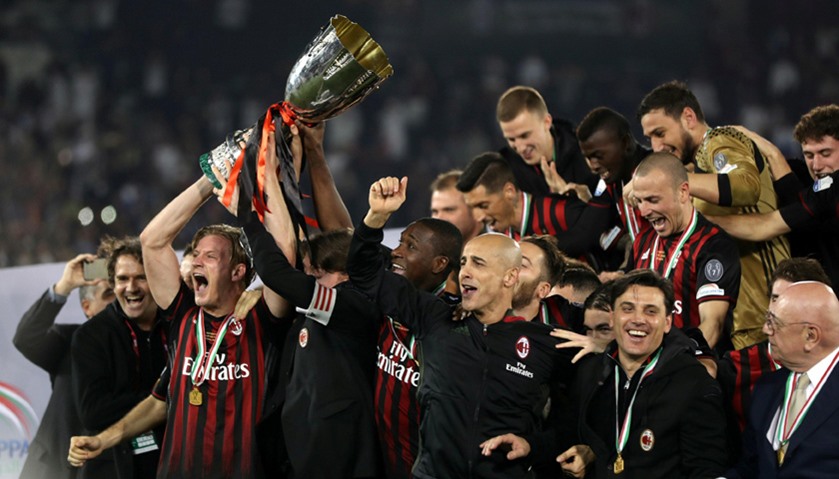 AC Milan\'s team celebrates with the trophy after beating Juventus.