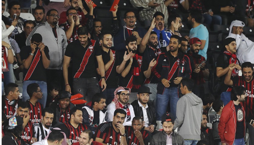 Fans cheer ahead of the Italian Super Cup final match between AC Milan and Juventus in Doha