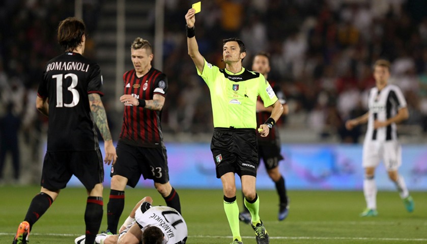 AC Milan\'s Alessio Romagnoli is shown a yellow card by the referee