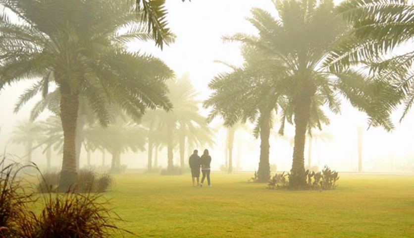 Residents walking along Corniche during the foggy conditions