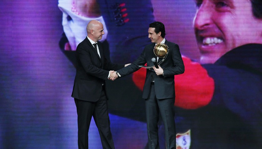 Paris St Germain coach Unai Emery (R) shakes hands with FIFA President Gianni Infantino