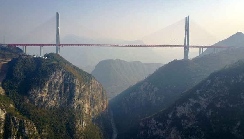 The Beipanjiang Bridge\'s four-lane road deck soars 564 metres over the Beipan River.