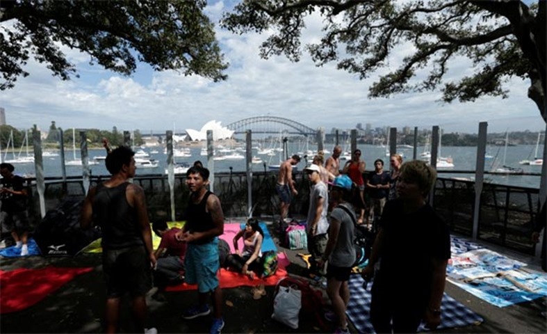 Early arrivals claim prime positions to watch the fireworks in Sydney on Saturday