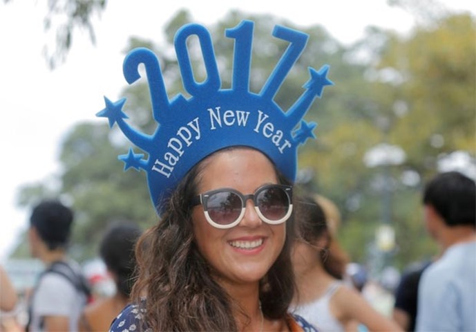 Chilean tourist Paula Aedo wears headwear to usher in 2017 as she arrives to watch the fireworks