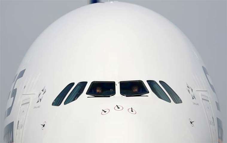 Pilots are seen in the cockpit as a Singapore Airlines\' A380 arrives at Changi Airport on Thursday