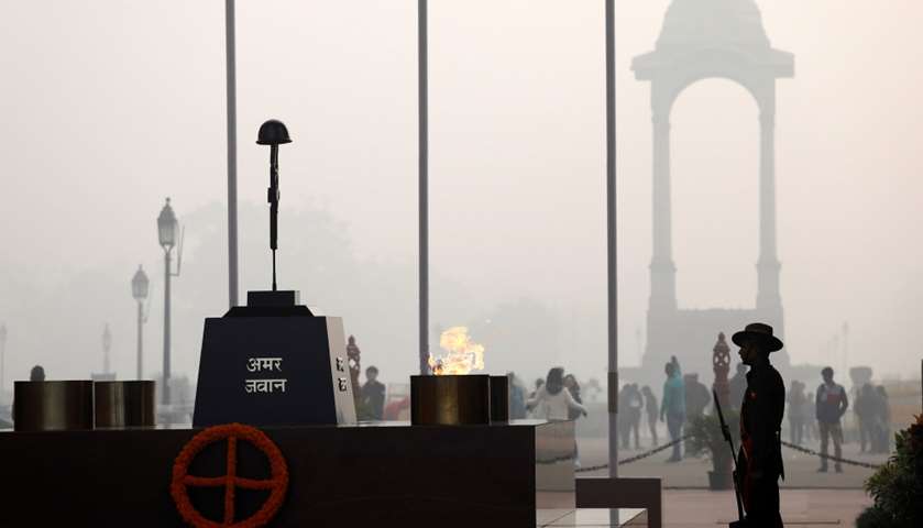 A soldier stands guard next to Amar Jawan Jyoti at the India Gate, New Delhi, India