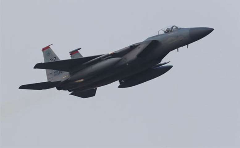 A US Air Force F-15C jet flies over a South Korean air base in Gwangju on Monday