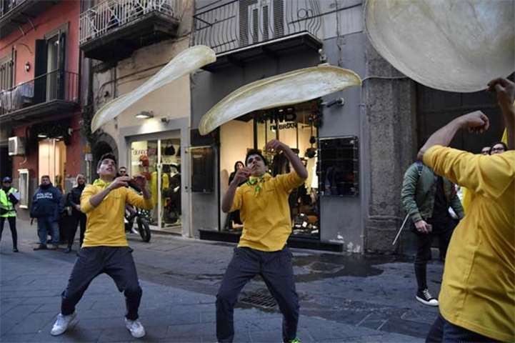 Members of the Pizzaioli Acrobats Coldiretti perform \"twirling\" pizza in Naples on Thursday