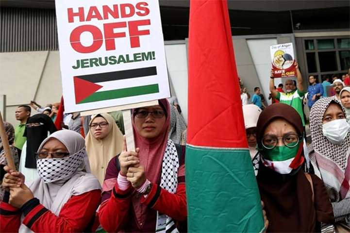 Malaysians hold placards during a demonstration outside the US embassy in Kuala Lumpur