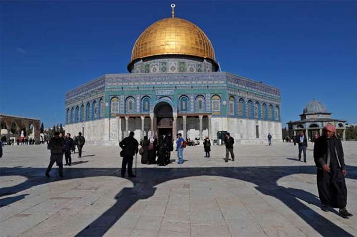 Palestinian worshippers walk in front of the Dome of the Rock mosque at the al-Aqsa compound