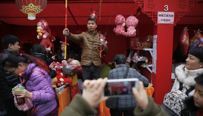 A vendor offers monkeys and other toys for sale at Ditan Park in Beijing