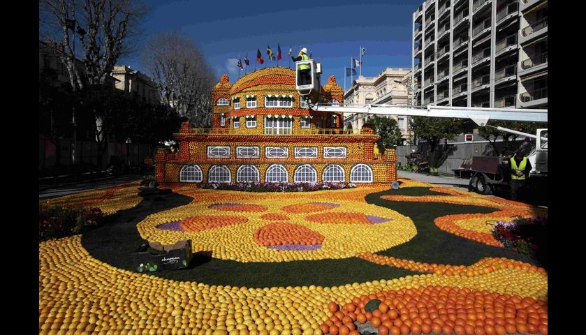 A worker puts the final touch to a sculpture made with lemons and oranges at the Lemon festival in M