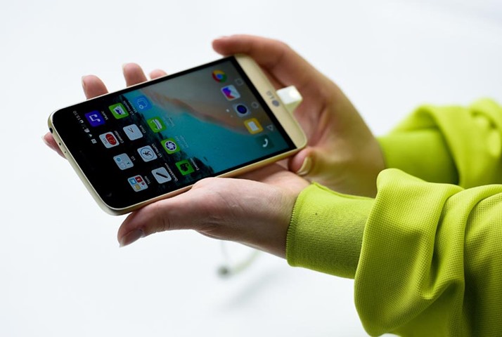 A hostess shows a new LG G5 during a press conference on the eve of the start of the event