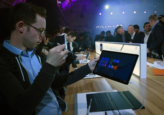 Visitors take pictures of a Matebook during a presentation by Chinese multinational Huawei